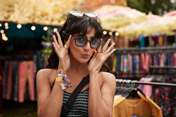 happy woman puckering while wearing sunglasses - concert stock pictures, royalty-free photos & images