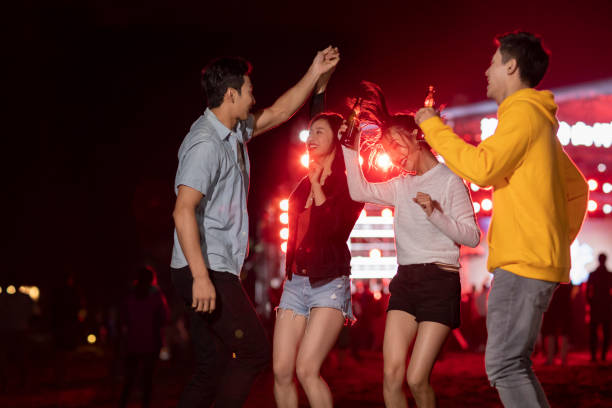 happy young chinese friends at music festival - concert stock pictures, royalty-free photos & images