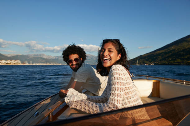 happy young couple enjoying in motorboat - travel stock-fotos und bilder