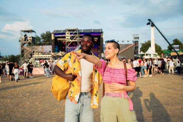 happy young couple is enjoying at a music festival - concert stock pictures, royalty-free photos & images