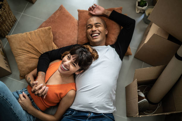 happy young couple lying on the floor at new home - home decoration stock pictures, royalty-free photos & images