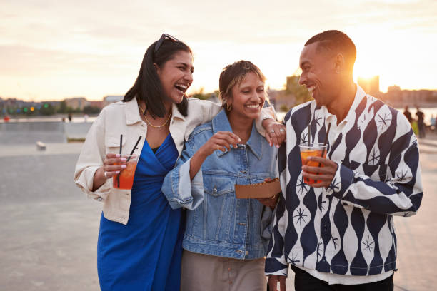 happy young multiracial friends enjoying food and drinks - junk food stock pictures, royalty-free photos & images