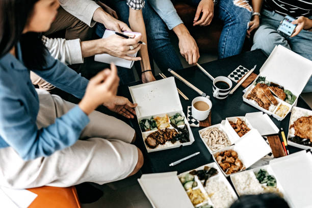 having lunch break while working on project - junk food stock pictures, royalty-free photos & images