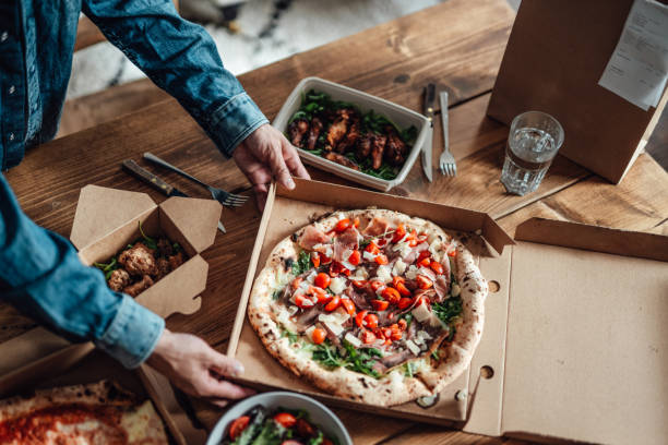having takeaway meal at home - junk food stock pictures, royalty-free photos & images