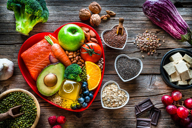 healthy food for lower cholesterol and heart care shot on wooden table - food stock pictures, royalty-free photos & images
