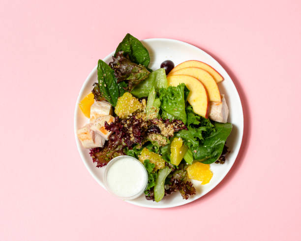 healthy salad with chicken, quinoa, spinach and orange. top view. copy space. - food stock pictures, royalty-free photos & images