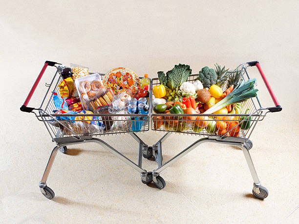 healthy vs unhealthy shopping trolleys - junk food stock pictures, royalty-free photos & images