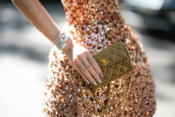 Heart Evangelista wears a beige brown with embroidered brown / green / silver sequined shoulder-off / puffy short dress, diamonds large rings, white...