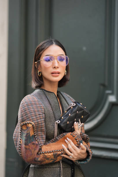 Heart Evangelista wears glasses, earrings, a leather bag outside Louis Vuitton, during the Womenswear Fall/Winter 2024/2025 as part of Paris Fashion...