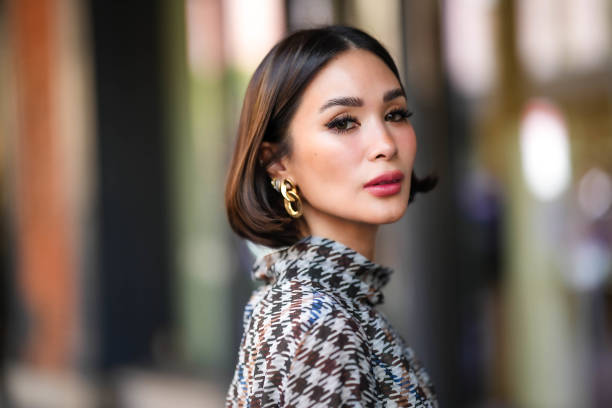 Heart Evangelista wears golden earrings, a houndstooth pattern printed dress, outside Carolina Herrera, during New York Fashion Week, on September...