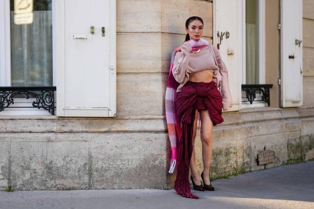 Heart Evangelista wears light pink pattern Acne Studios scarf, light pink cropped Acne Studios sweater, burgundy bordeaux high waisted bow Acne...