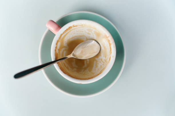high angle view of an empty glass cup of coffee on table in cafe shop against a white backgrounds - junk food stock pictures, royalty-free photos & images