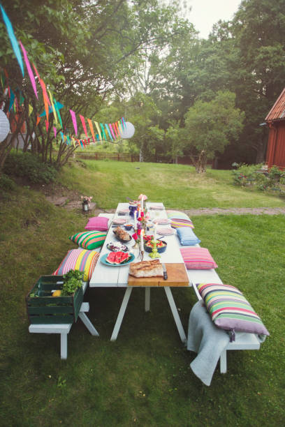 high angle view of decorated picnic table in backyard at garden party - garden decoration stock pictures, royalty-free photos & images