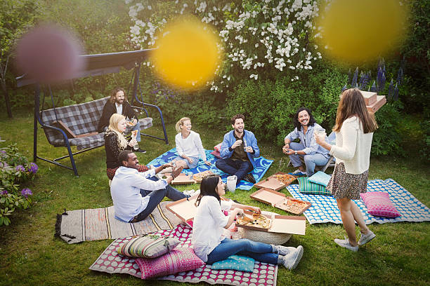 high angle view of friends having snacks during summer party at yard - garden decoration stock pictures, royalty-free photos & images