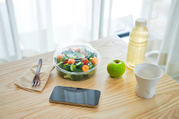 high angle view of salad in a transparent plastic container still life. - junk food stock pictures, royalty-free photos & images