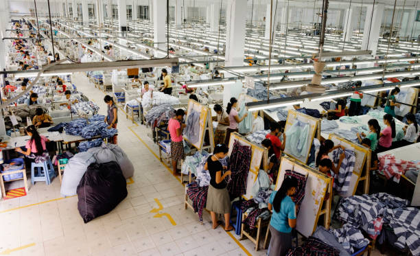 high angle view of workers in garment factory - fashion stock-fotos und bilder