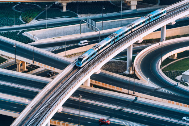 highway intersection and metro train in dubai, uae - travel stock pictures, royalty-free photos & images
