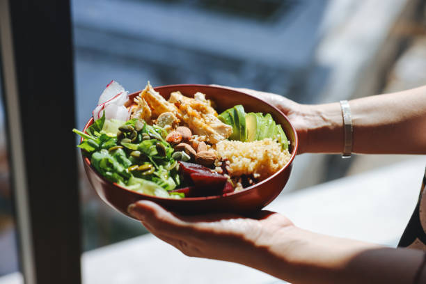 holding a bowl of chicken salad - food stock pictures, royalty-free photos & images