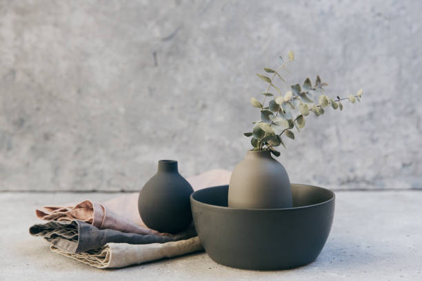 home decor - neutral coloured vases and dish-ware and linen napkin in nordic style against grey wall. - home decoration stockfoto's en -beelden