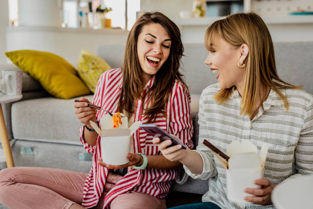 home delivery of food for two friends - junk food stock pictures, royalty-free photos & images