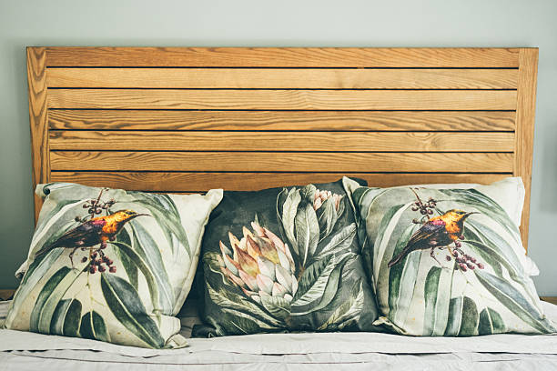 home interior. bed with colored cushions. - home decoration stock pictures, royalty-free photos & images