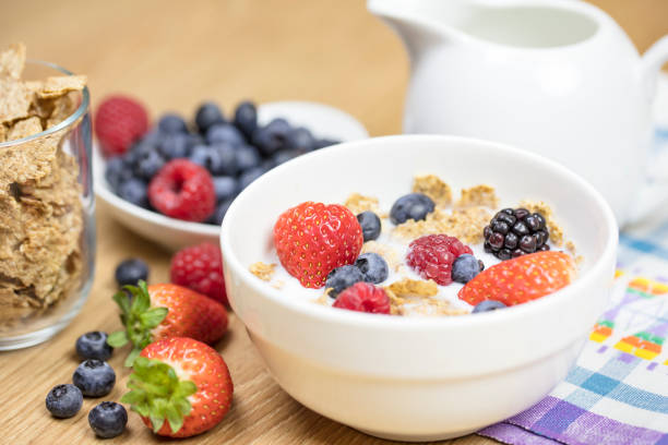 homemade granola or muesli with oat flakes, corn flakes, dried fruits with fresh berries in a bowl. healthy breakfast - junk food stock pictures, royalty-free photos & images