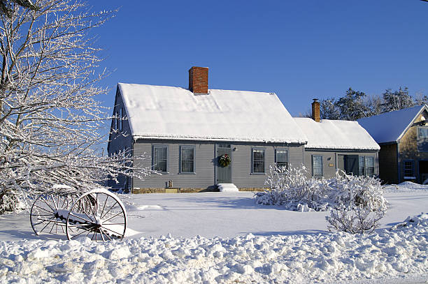 house covered in snow with two chimneys and many windows - garden decoration stock pictures, royalty-free photos & images