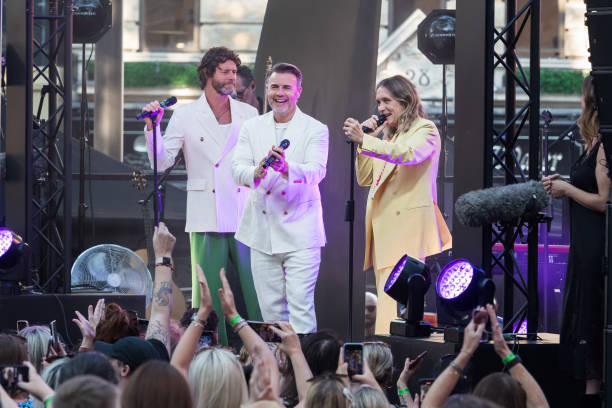 Howard Donald, Gary Barlow and Mark Owen from Take That perform on stage during the world premiere of 'Greatest Days', the cinematic adaptation of...