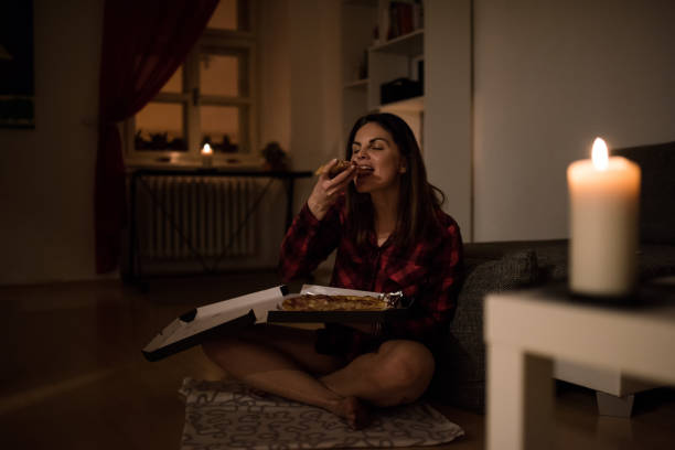 hungry woman having a slice of pizza - junk food stock pictures, royalty-free photos & images