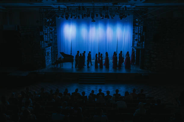 in silhouette choir getting ready on stage theatre - concert stock pictures, royalty-free photos & images