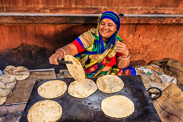 indian street vendor preparing food - chapatti, flat bread - food stock pictures, royalty-free photos & images