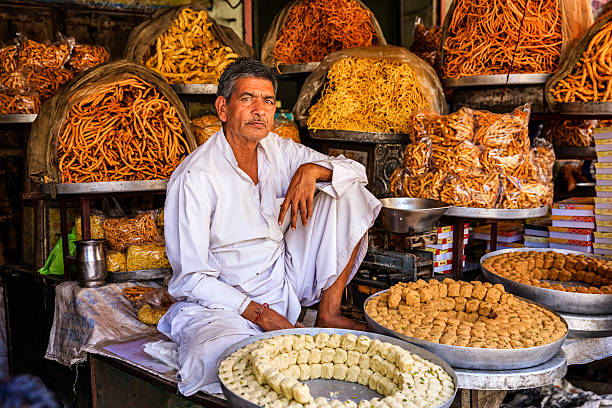 indian street vendor selling sweets near jaipur, india - food stockfoto's en -beelden