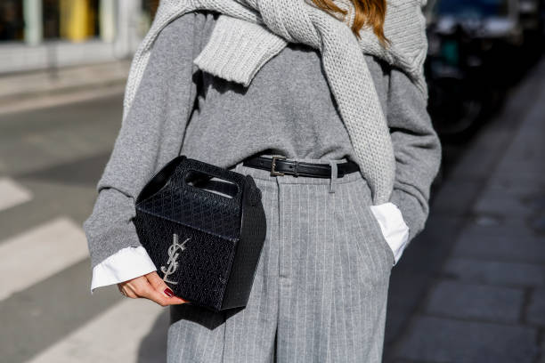 Influencer Alexandra Lapp, wearing a Seidensticker blouse in white, Rossi pinstriped pants in grey, a H&M cashmere sweater in grey, a Allude knit...