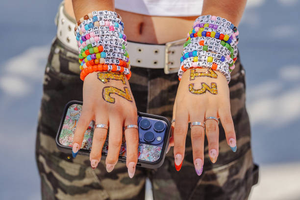 Inglewood, CA Taylor Swift fan Emma Sadeghi, of Glendale, shows her friendship bracelets as she arrives at the emporarily renamed "Speak Now/Taylor's...