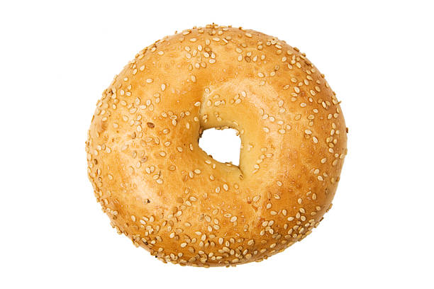 isolated close-up of of sesame bagel on a white background - food stock pictures, royalty-free photos & images
