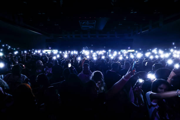 Jackson State University students raise their cell phones and illuminate the crowd during Thee Homecoming Concert at the Lee E. Williams Athletic &...