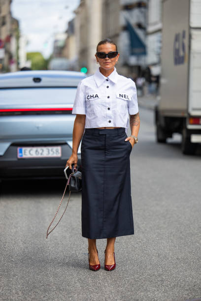 Janka Polliani wears white Chanel button shirt, black skirt, bag outside Gestuz during day four of the Copenhagen Fashion Week SS25 on August 08,...