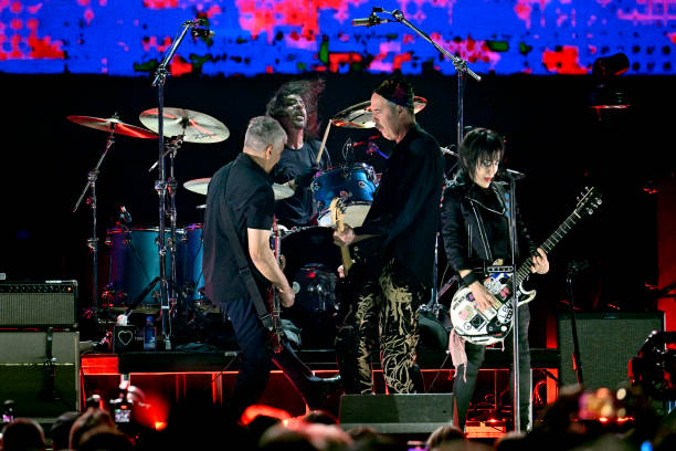 Joan Jett performs onstage with Pat Smear, Dave Grohl, and Krist Novoselic of Nirvana during the FIREAID Benefit Concert for California Fire Relief...