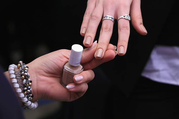 Julie Kandalec, essie Celebrity Manicurist, polishes models' nails for Proenza Schouler Fall/ Winter 2016 during New York Fashion Week at the Whitney...