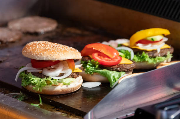 July 2023, Baden-Württemberg, Rottweil: Burgers are prepared at a food stand at an event in Rottweil. Photo: Silas Stein/dpa