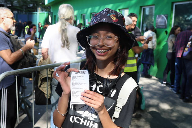 June 2023, Brazil, São Paulo: A young woman shows a tiket just bought at the Allianz Parque stadium for "The Eras Tour" by Taylor Swift. After riots...