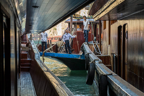 junk culture, sailors look on floating hotels in ha long bay, vietnam - junk food fotografías e imágenes de stock