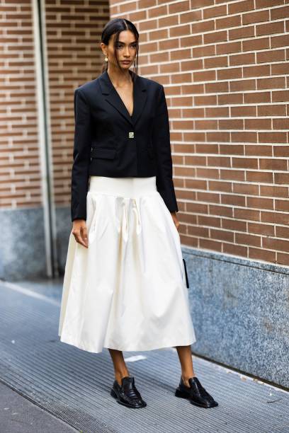 Kelly Gale is seen wearing a white wide skirt and short black blazer outside Fendi show during the Milan Fashion Week - Womenswear Spring/Summer 2024...