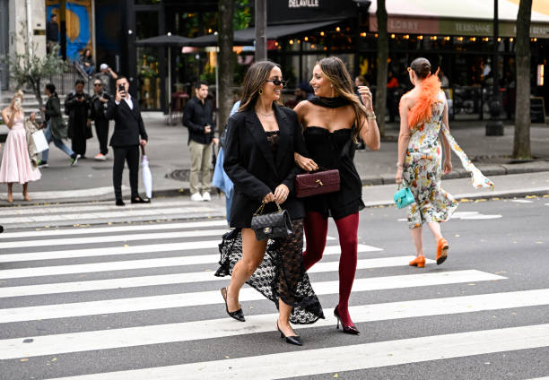 Kerry Denevan is seen wearing a black blazer, laced dress, black heels and sunglasses with a Chanel bag with Lya Mariella is seen wearing a Windsor...