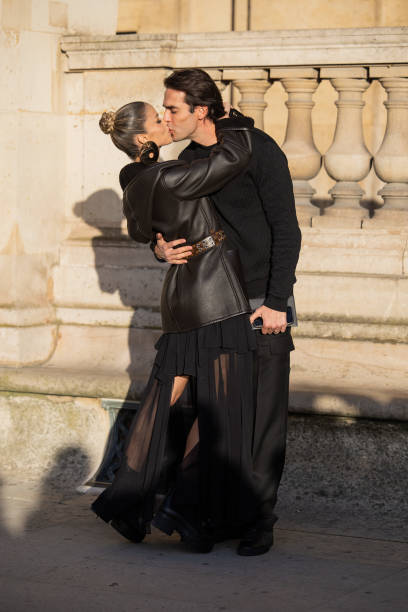 Kissing couple Carolina Dias wears black belted jacket, skirt & Ricardo Izecson dos Santos Leite, a.k.a. Kaká outside Louis Vuitton during Womenswear...