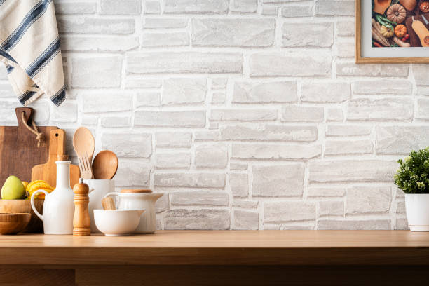 kitchen countertop with utensils and brick wall background. copy space available - food stock pictures, royalty-free photos & images
