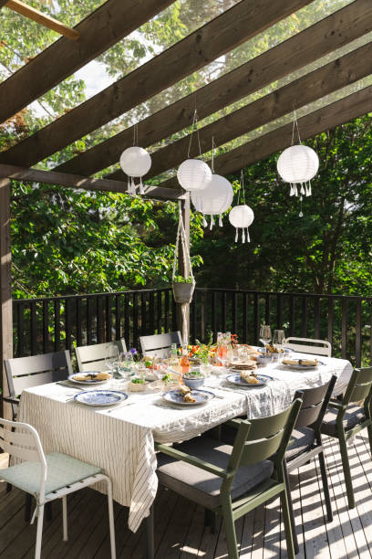 lanterns hanging over dining table at patio - garden decoration stock pictures, royalty-free photos & images