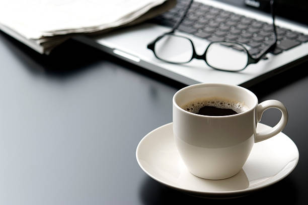 laptop and a cup of coffee on office desk - coffee stock pictures, royalty-free photos & images