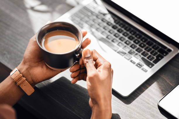 laptop, keyboard or hands of black man with coffee to relax, drink or enjoy during morning work break. cup of tea for person working on social media content writing, online blog or digital seo mockup - coffee stockfoto's en -