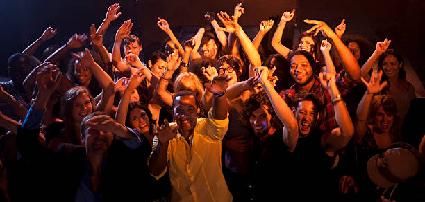 large crowd pointing at camera - concert stock pictures, royalty-free photos & images